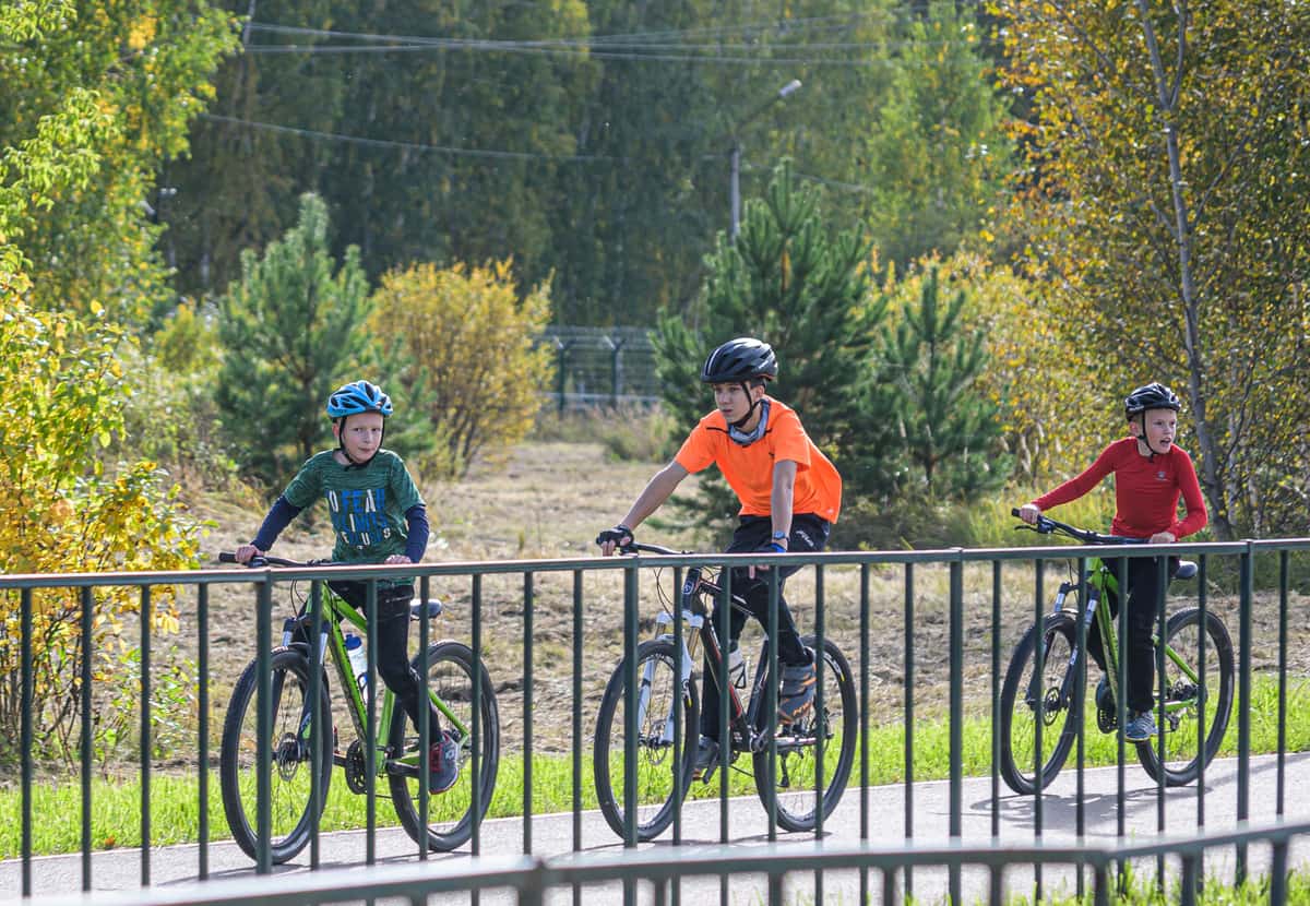 Older children riding bikes on a path