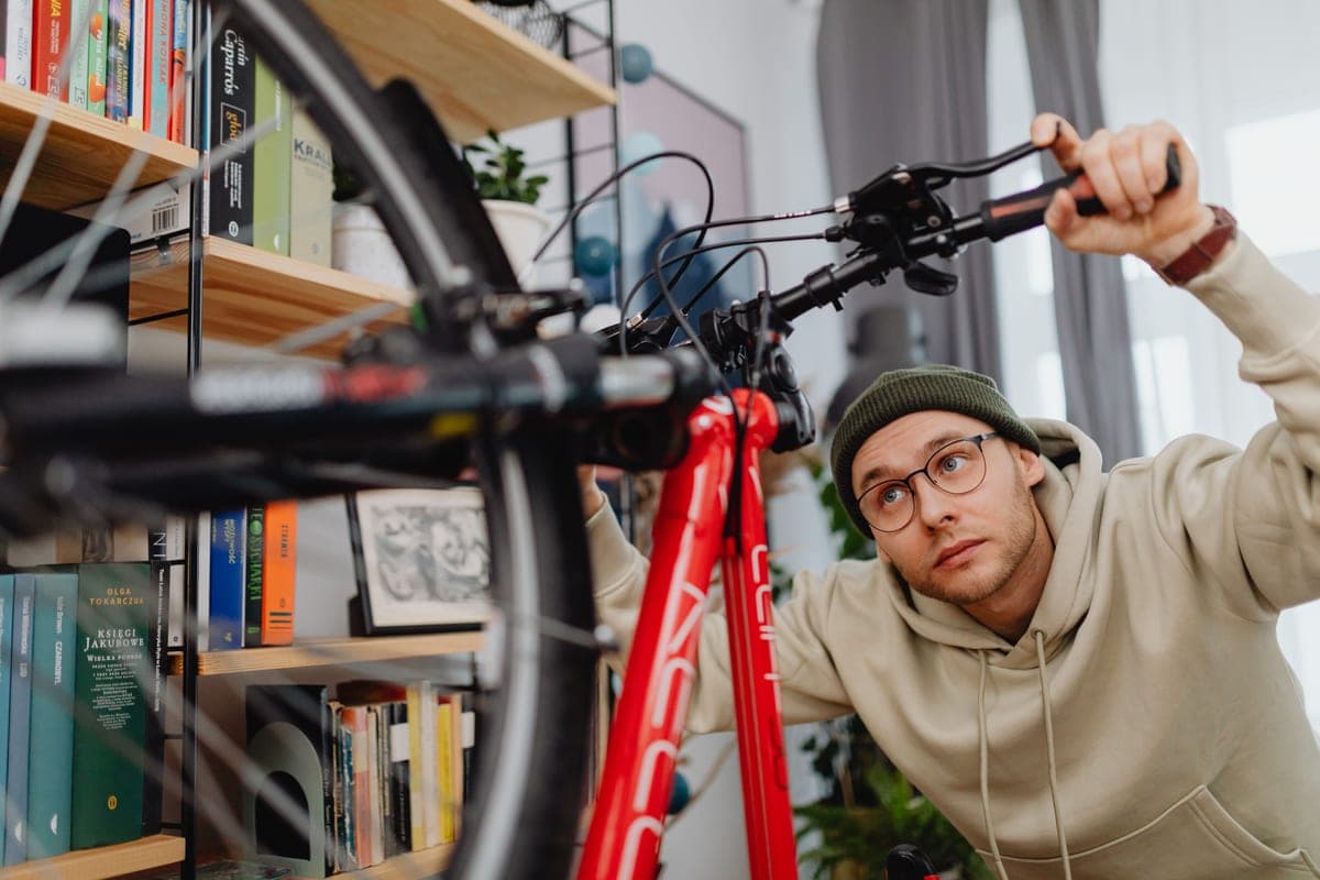 A person repairing a bicycle with tools
