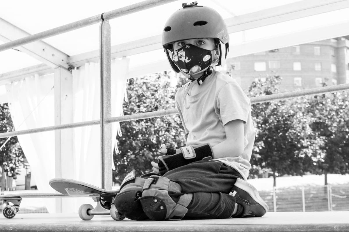 A child in a helmet with protective gear